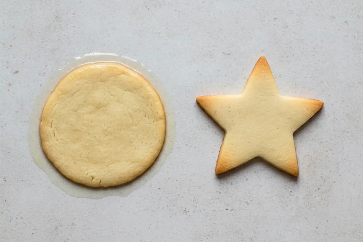 Side-by-side comparison of two cookies one spread out from excess moisture, one holding sharp cut-out edges